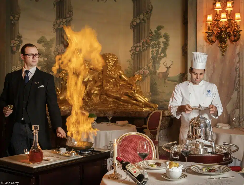 Pink Lady® Food Photographer of the Year image shows waiter and chef cooking in the Ritz. 